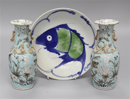 A pair of Chinese vases decorated dragons and foliage in white and brown on a pale turquoise ground and a provincial dish